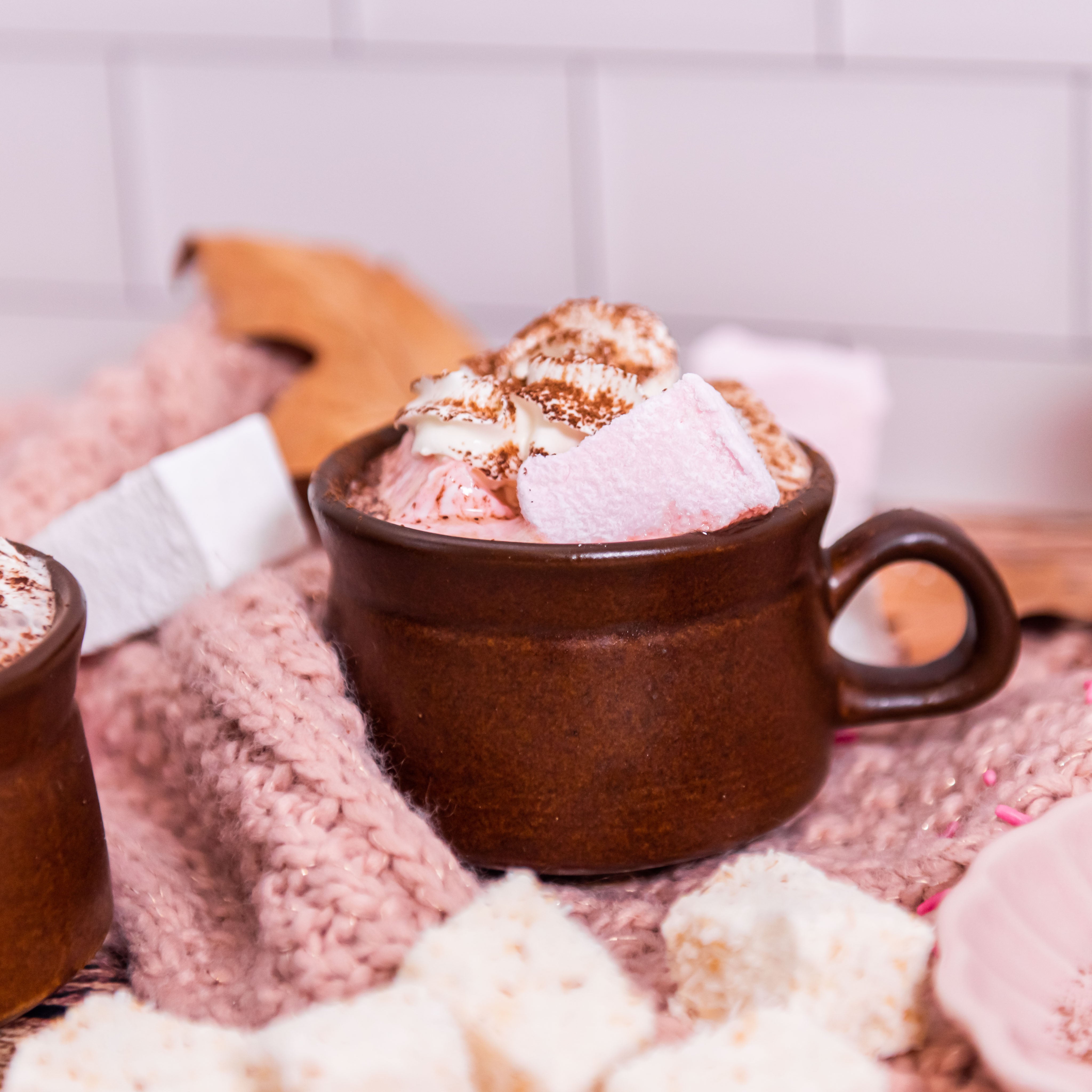 Mug with Hot chocolate, cream and marshmallows in it.